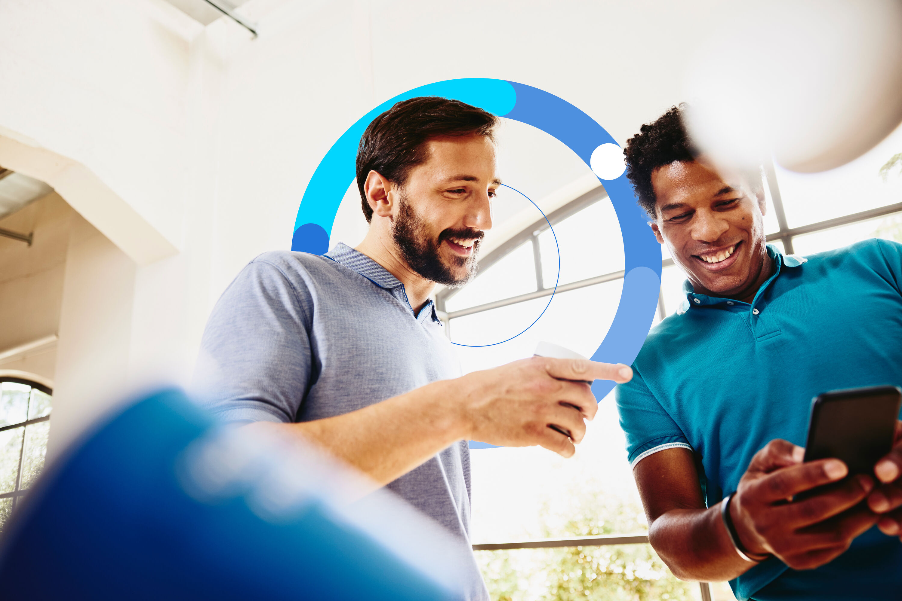 two man smiling and looking at the phone
