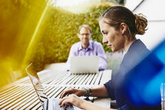 this is a woman and a man working on the computer