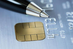 A pen placed over a credit card