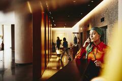 Hotel receptionist answering the phone. 