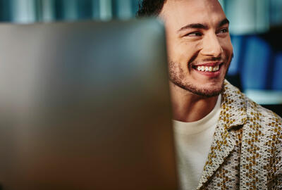 Side profile of a smiling man.