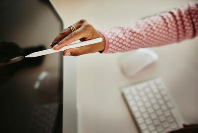 a person using a stylus on a screen