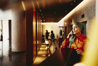 Hotel receptionist answering the phone. 
