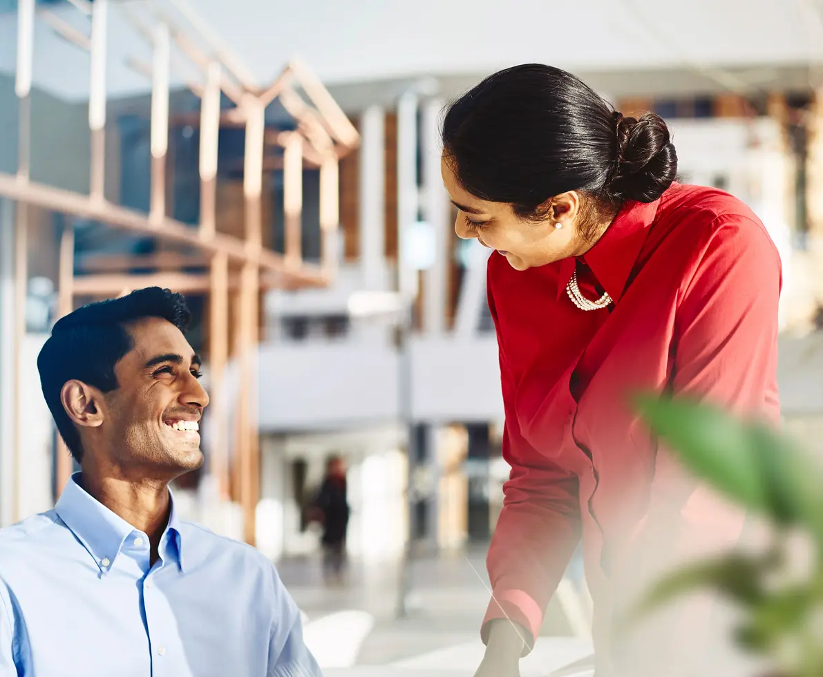 male and female talking and smiling.