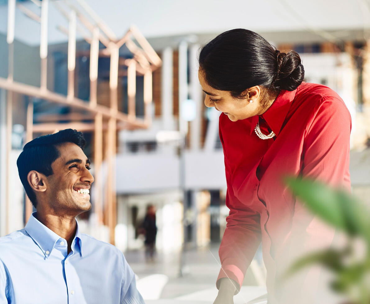 male and female talking and smiling.