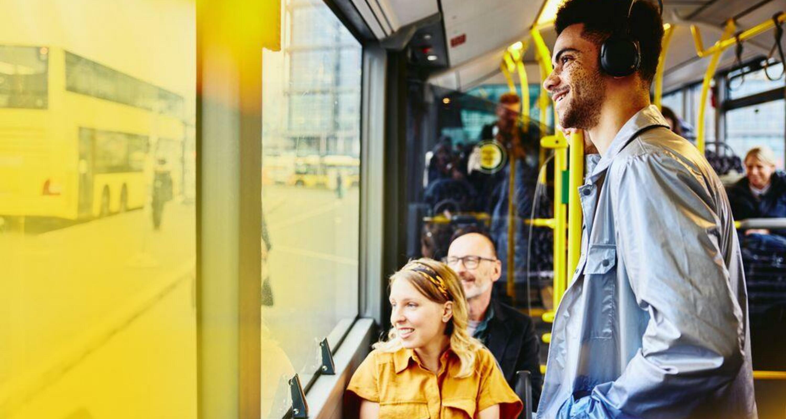 people riding the bus and smiling